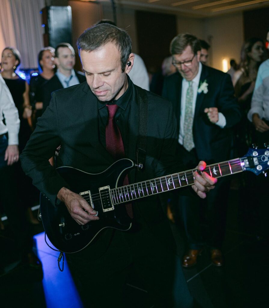 Guitarist playing during evening celebration