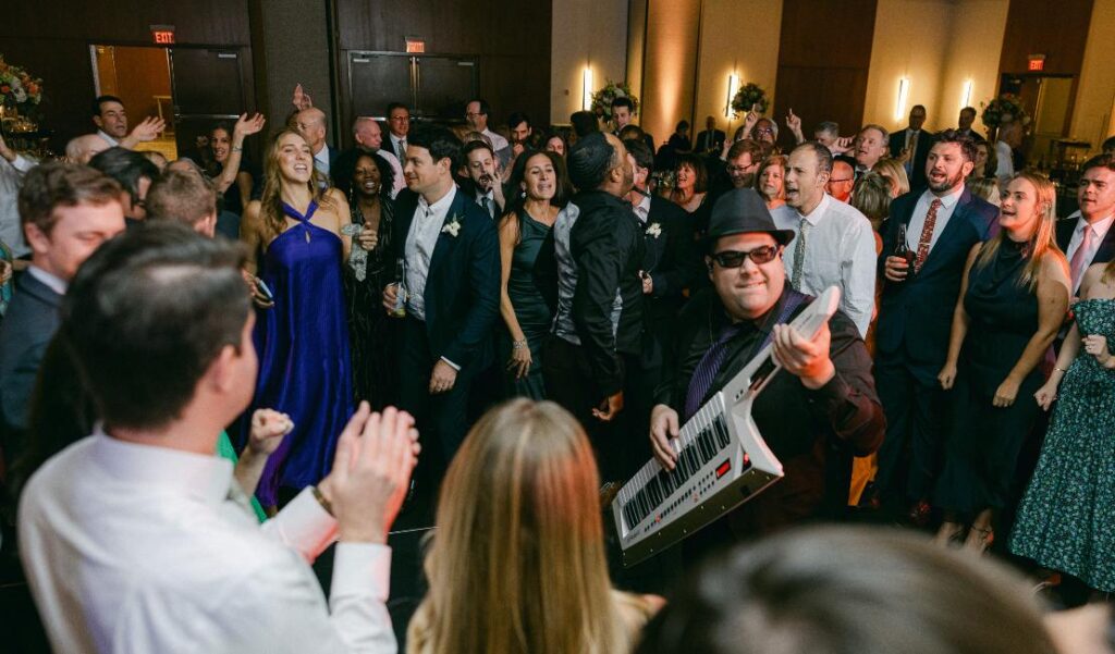 Packed dance floor with live band performance